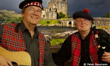 Peter Baumann (mit Gitarre) und Henning Wilms (mit Dudelsack) in traditioneller schottischer Kleidung.. 
