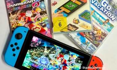Foto von der Gamingkonsole Switch mit drei Switch Spielen