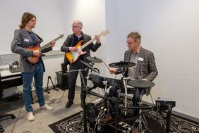 Dr. Norbert Kamp, Dr. Michael Meyer, Vorsitzender des Freundeskreises Stadtbüchereien Düsseldorf und Vorstand der Stadtsparkasse, sowie Musikpädagoge Antonius Grützner (v.r.n.l.) präsentieren die neuen Instrumente