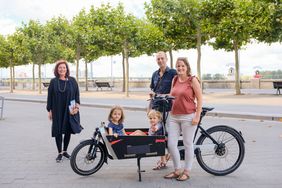 Umweltdezernentin Helga Stulgies (li.) überreichte der Familie Holger, Nina, Emma (6) und Lasse (2) Thomas den Preis für ihren Siegerbeitrag bei der Klimachallenge des Umweltamtes - ein E-Lastenfahrrad. Foto: Michael Gstettenbauer