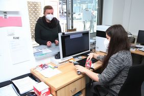 D.Live-Mitarbeiterin Monie Wilhelm empfängt die Mitarbeitenden des Impfzentrums und Impflinge priorisierter Berufsgruppen in der Akkreditierungsstelle. Foto: David Young