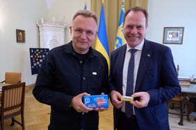 Bürgermeister Andriy Sadovyy und Oberbürgermeister Dr. Stephan Keller tauschten Schokolade als Gastgeschenke aus. OB Keller erhielt die Schokolade des Reahbilitationszentrums "Unbroken". Foto: LHD