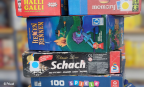 Foto von einem Stapel mit Brettspielen in einer Bibliothek