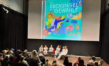 Foto von Kindern des Garather Kinderparlaments bei einer Lesung im Kulturhaus Süd